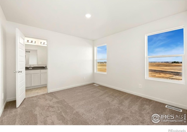 3218 Buffalo Grass Ln, Wellington, CO 80549 - unfurnished bedroom with light colored carpet, baseboards, and multiple windows