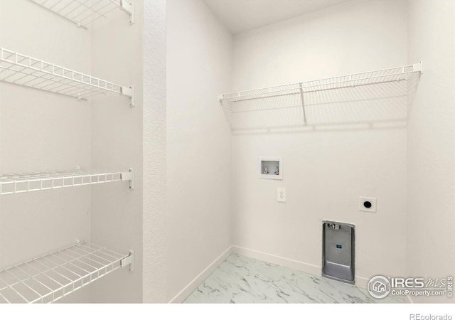 3218 Buffalo Grass Ln, Wellington, CO 80549 - laundry area with light marble finish flooring, electric dryer hookup, washer hookup, and baseboards