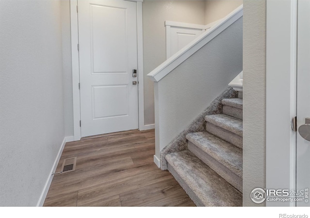 entryway with hardwood / wood-style floors