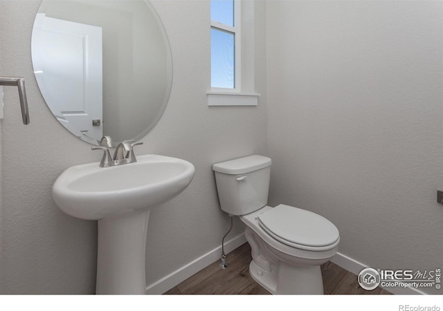 bathroom featuring hardwood / wood-style floors and toilet