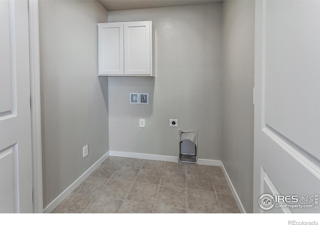 clothes washing area with hookup for an electric dryer, cabinets, and washer hookup