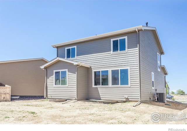 back of house with central AC unit