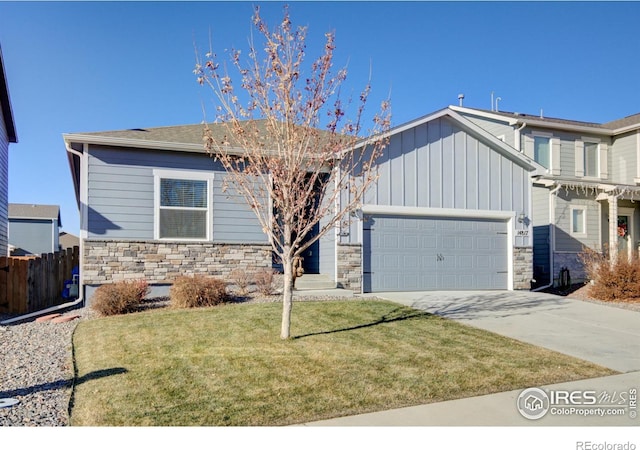 view of front of property featuring a garage and a front lawn