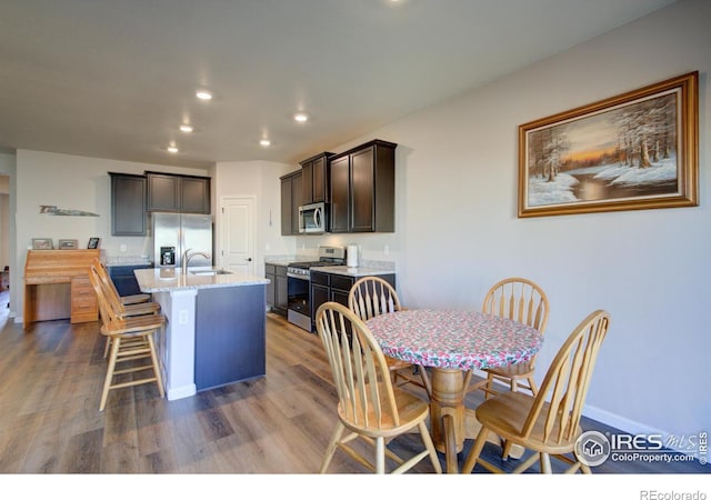 dining space featuring sink and hardwood / wood-style flooring