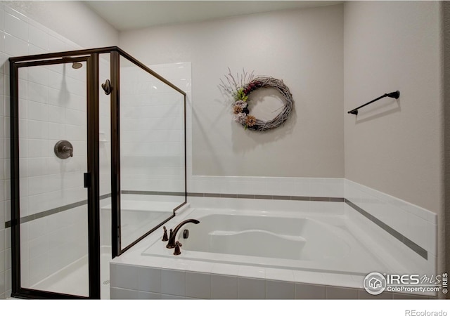 bathroom with shower with separate bathtub