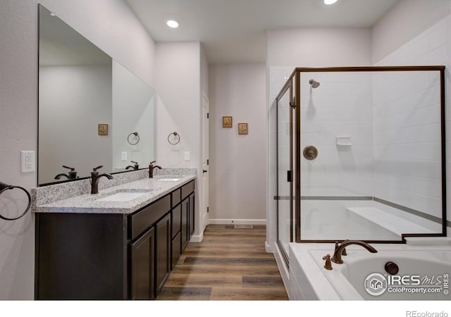 bathroom featuring wood-type flooring, vanity, and separate shower and tub