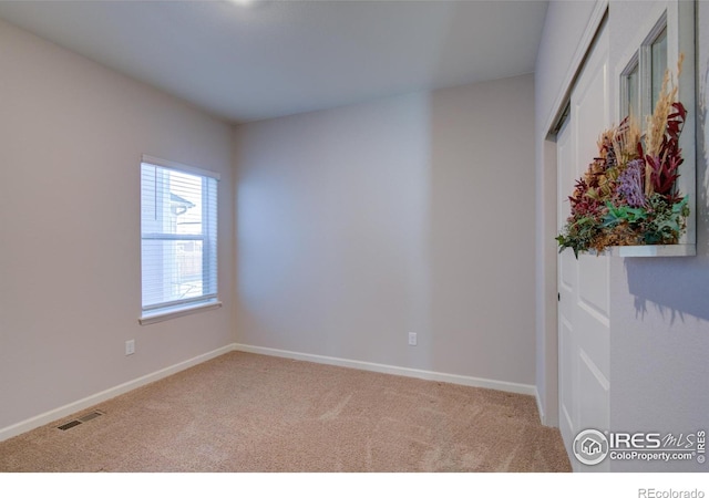 unfurnished room with carpet floors