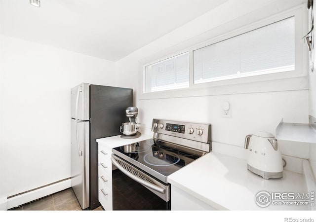 kitchen featuring stainless steel electric range oven and a baseboard heating unit