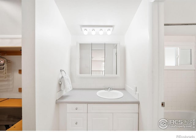 bathroom with vanity and a bath