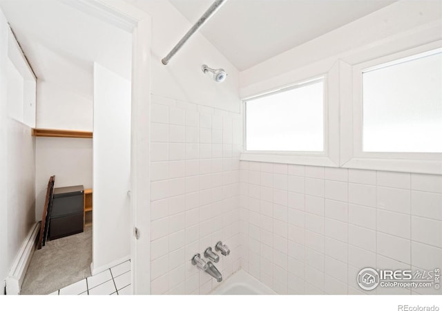 bathroom featuring tile patterned floors and tiled shower / bath combo