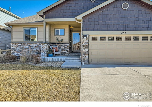 view of front of property with a garage and a front lawn