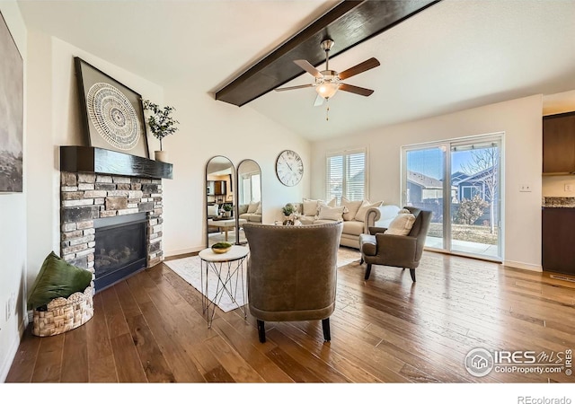 living room with vaulted ceiling with beams, ceiling fan, a fireplace, and dark hardwood / wood-style floors