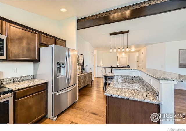 kitchen with light stone countertops, appliances with stainless steel finishes, beam ceiling, decorative light fixtures, and light hardwood / wood-style floors