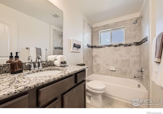 full bathroom featuring tile patterned flooring, vanity, toilet, and tiled shower / bath