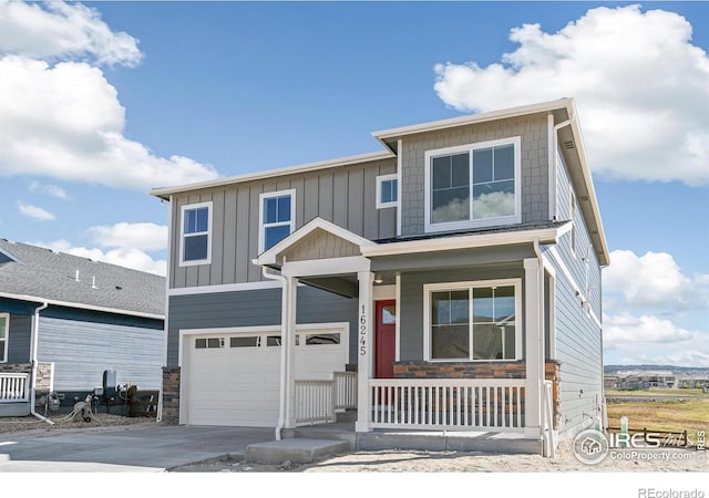 view of front of house featuring a porch and a garage