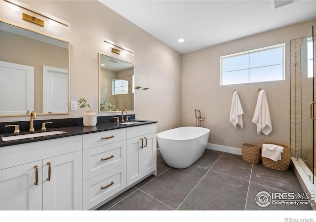 bathroom featuring vanity, tile patterned floors, and shower with separate bathtub