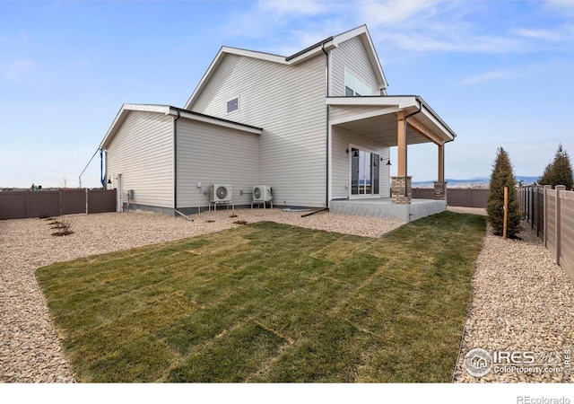 back of house with ac unit, a patio area, and a yard