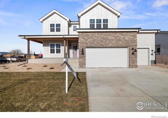 view of front facade with a garage, a front yard, and a porch