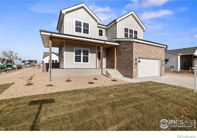 view of front of house featuring a front yard, covered porch, and a garage