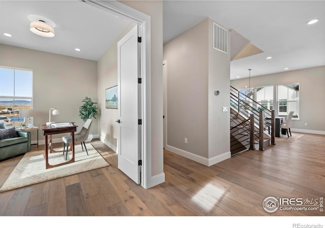 hallway with light hardwood / wood-style floors