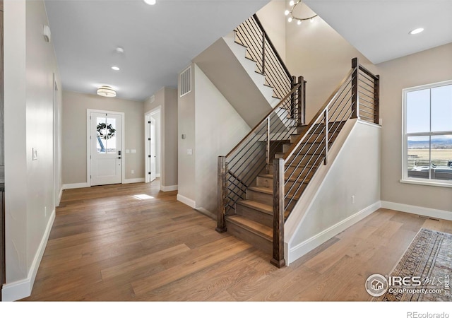 foyer entrance with light hardwood / wood-style flooring and plenty of natural light