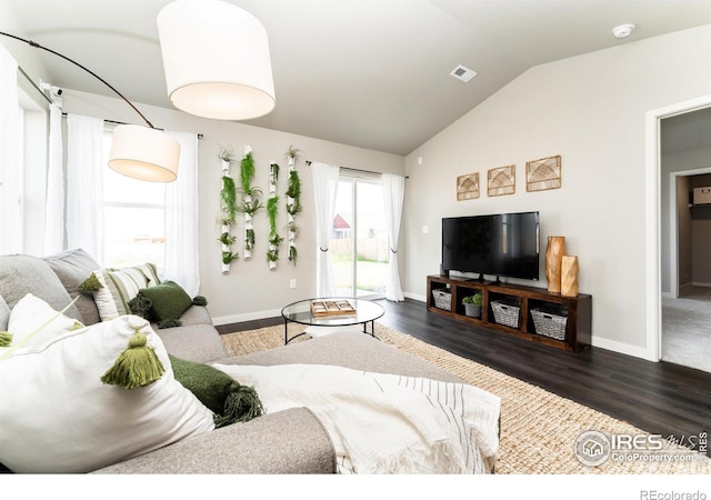 living room with dark hardwood / wood-style flooring and lofted ceiling