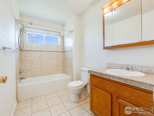 full bathroom with toilet, vanity, tile patterned floors, and tiled shower / bath