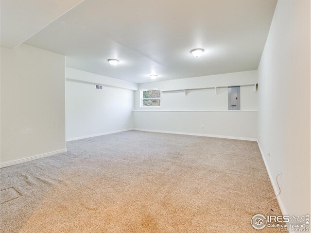 spare room featuring carpet flooring and electric panel