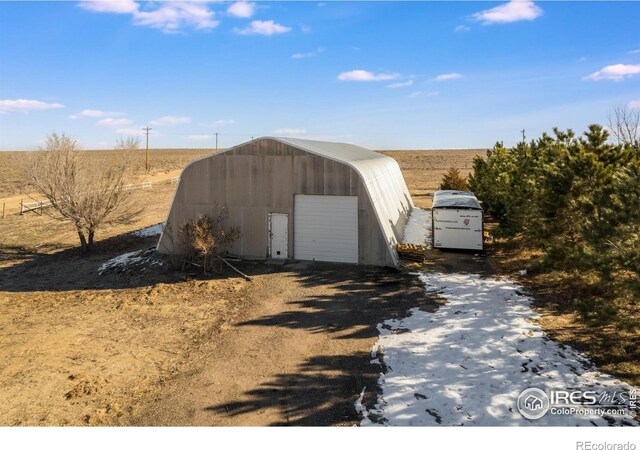 view of outbuilding with a rural view