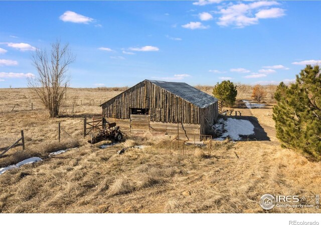 exterior space featuring a rural view and an outdoor structure