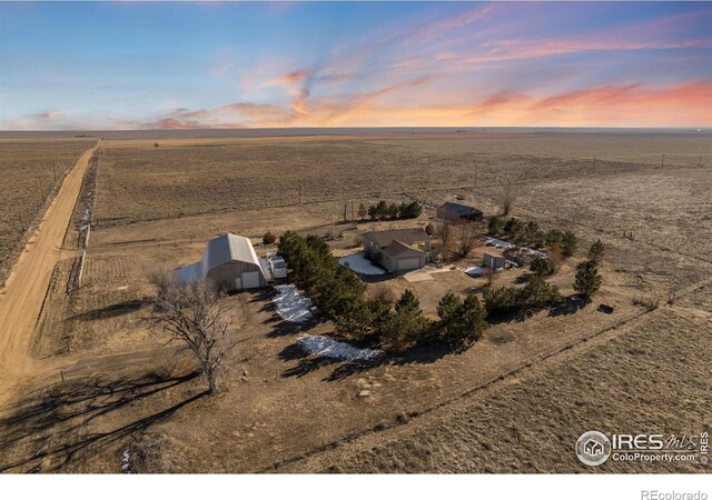 aerial view at dusk featuring a rural view