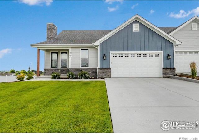 view of front of property with a front yard and a garage