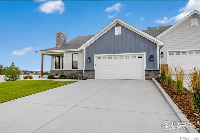 view of front of home with a garage and a front lawn