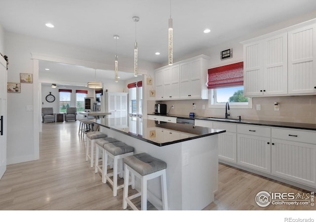 kitchen featuring pendant lighting, a center island, and a healthy amount of sunlight