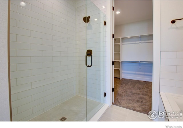 bathroom with tile patterned floors and walk in shower