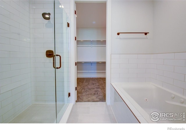 bathroom featuring tile patterned floors and plus walk in shower