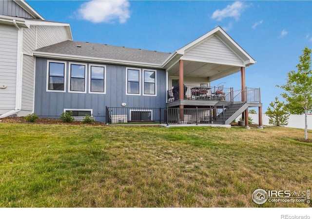 back of house featuring a yard and a deck