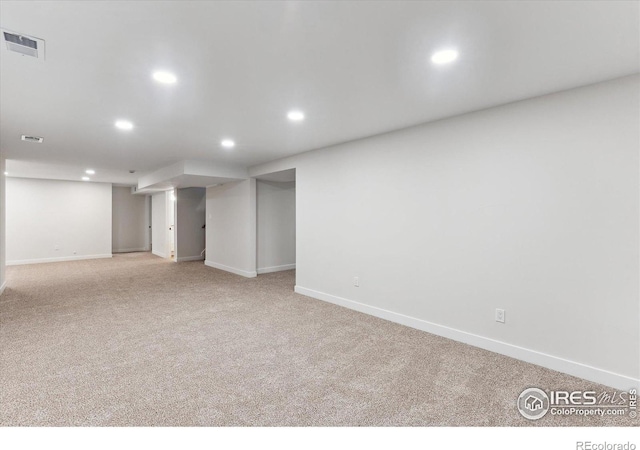 basement featuring light colored carpet