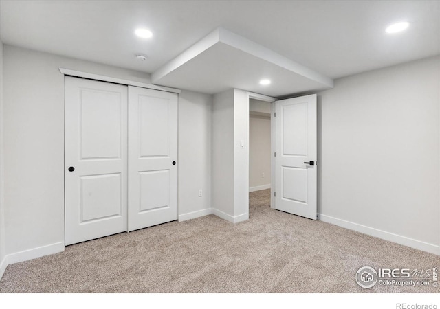 basement featuring light colored carpet