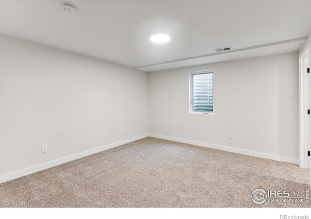 unfurnished room with light carpet