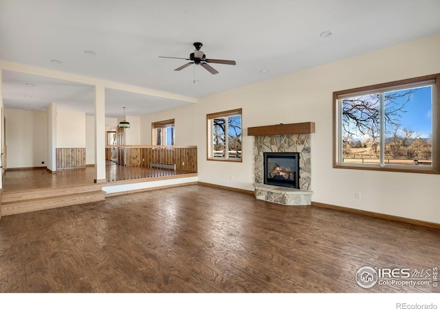 unfurnished living room with ceiling fan, dark hardwood / wood-style floors, and a fireplace