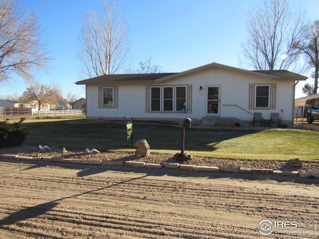 ranch-style home featuring a front yard