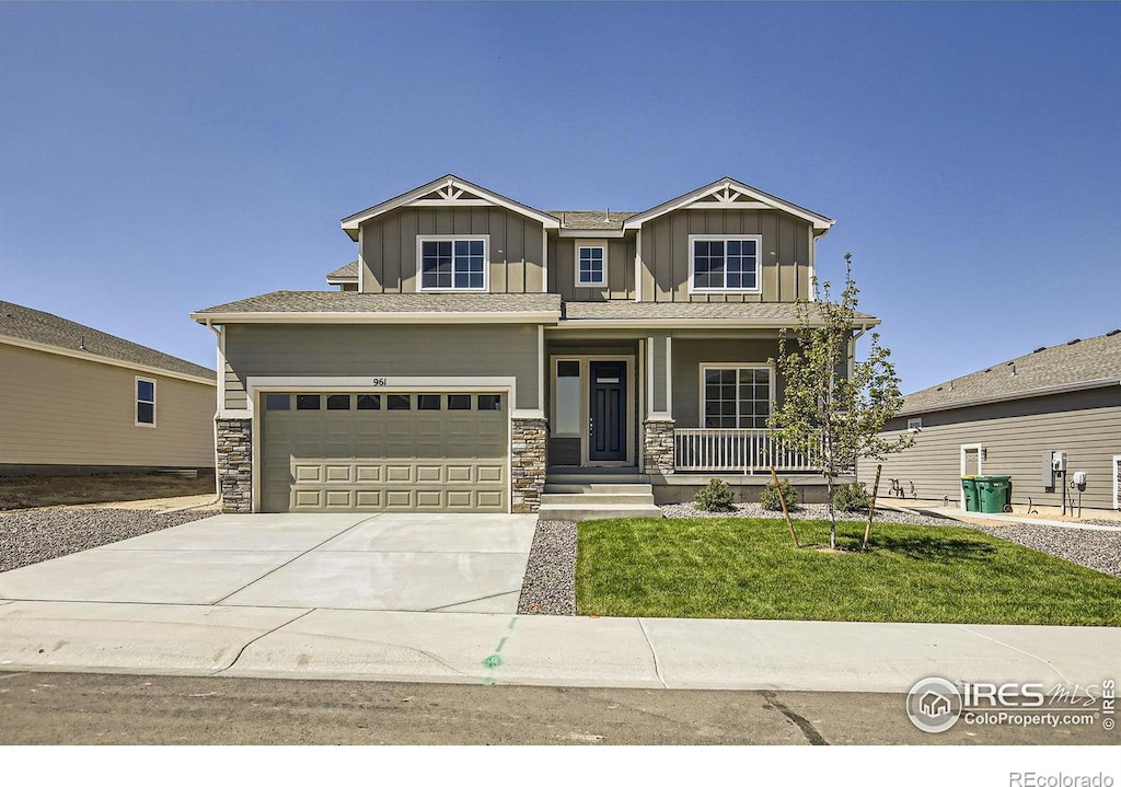 craftsman-style house with a front yard, a porch, and a garage