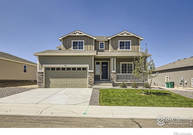 craftsman-style house with a front yard, a porch, and a garage