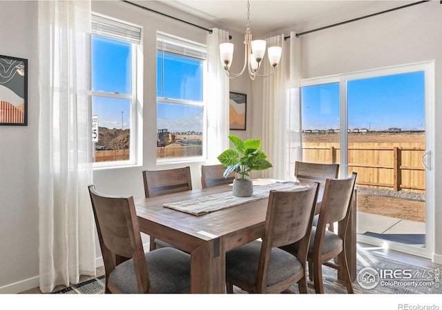 dining area with an inviting chandelier and plenty of natural light