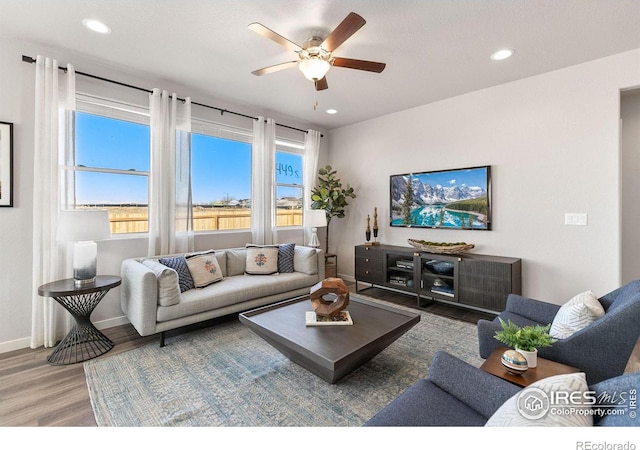 living room featuring hardwood / wood-style flooring and ceiling fan