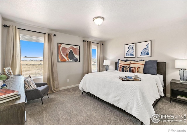 carpeted bedroom with a textured ceiling