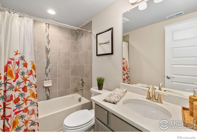 full bathroom featuring shower / bath combo, vanity, and toilet