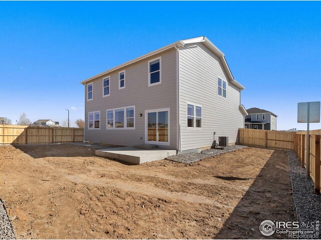 back of property featuring central AC unit