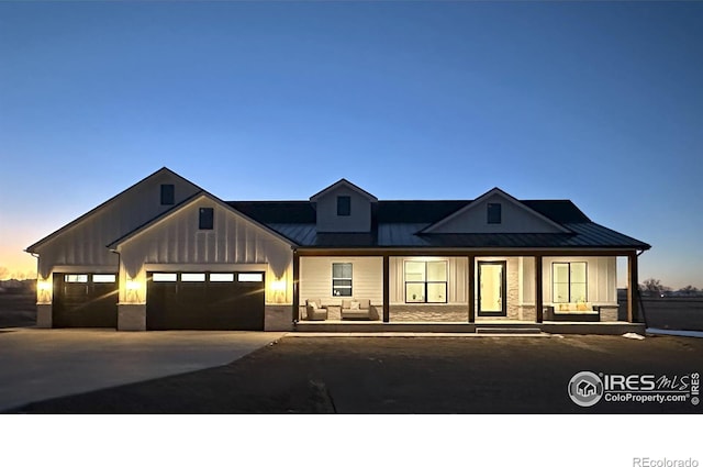 modern inspired farmhouse with covered porch and a garage